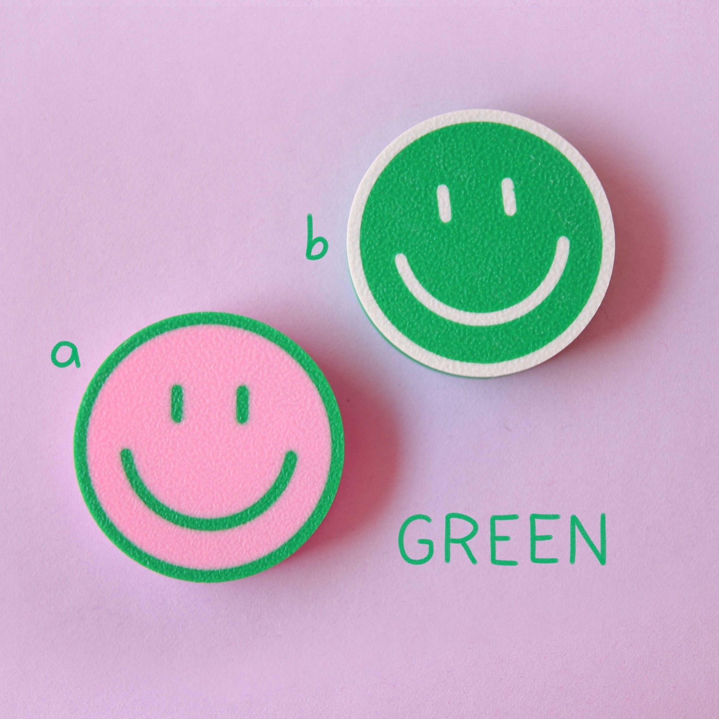 green, pink and white 3D-printed smiley magnets