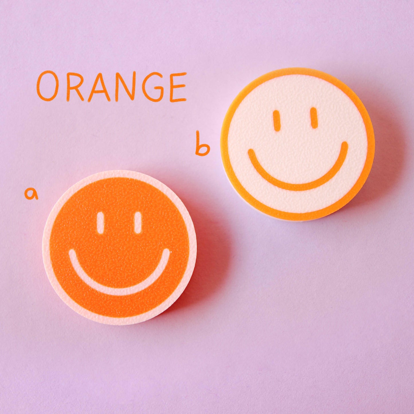 orange and white 3D-printed smiley magnets