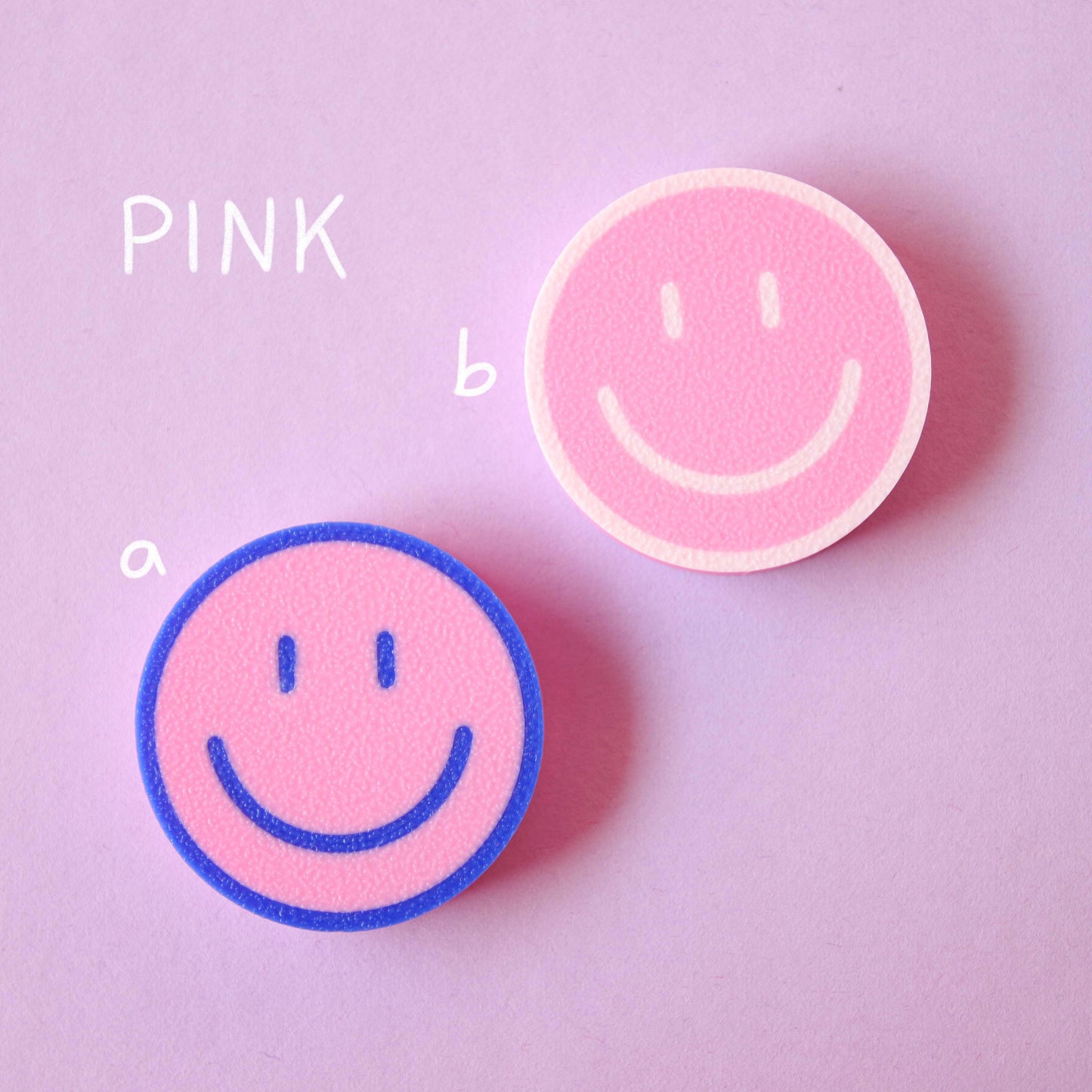 blue, pink and white 3D-printed smiley magnets