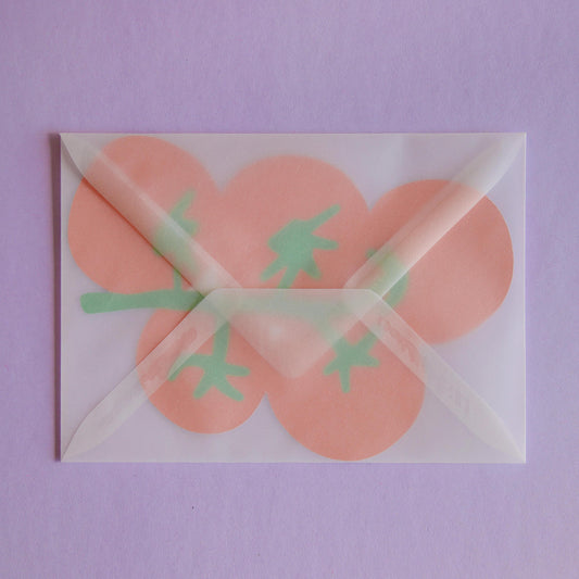 a postcard shaped like a bunch of tomatoes inside a transparent envelope