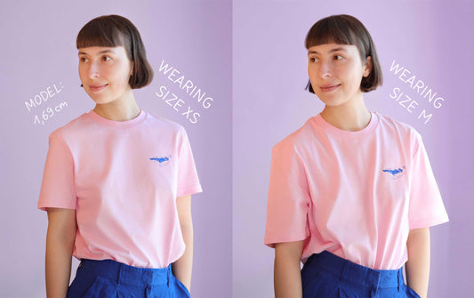 comparison of a model wearing unisex pink shirt in size xs and size m