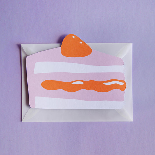 a postcard shaped like a piece of cake on a transparent envelope