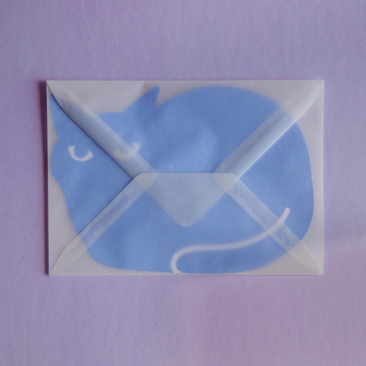 a postcard shaped like a cat inside a transparent envelope