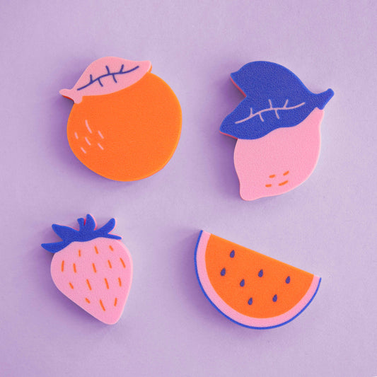 colorful 3D-printed magnets in the shape of fruit: orange, strawberry, lemon and melon