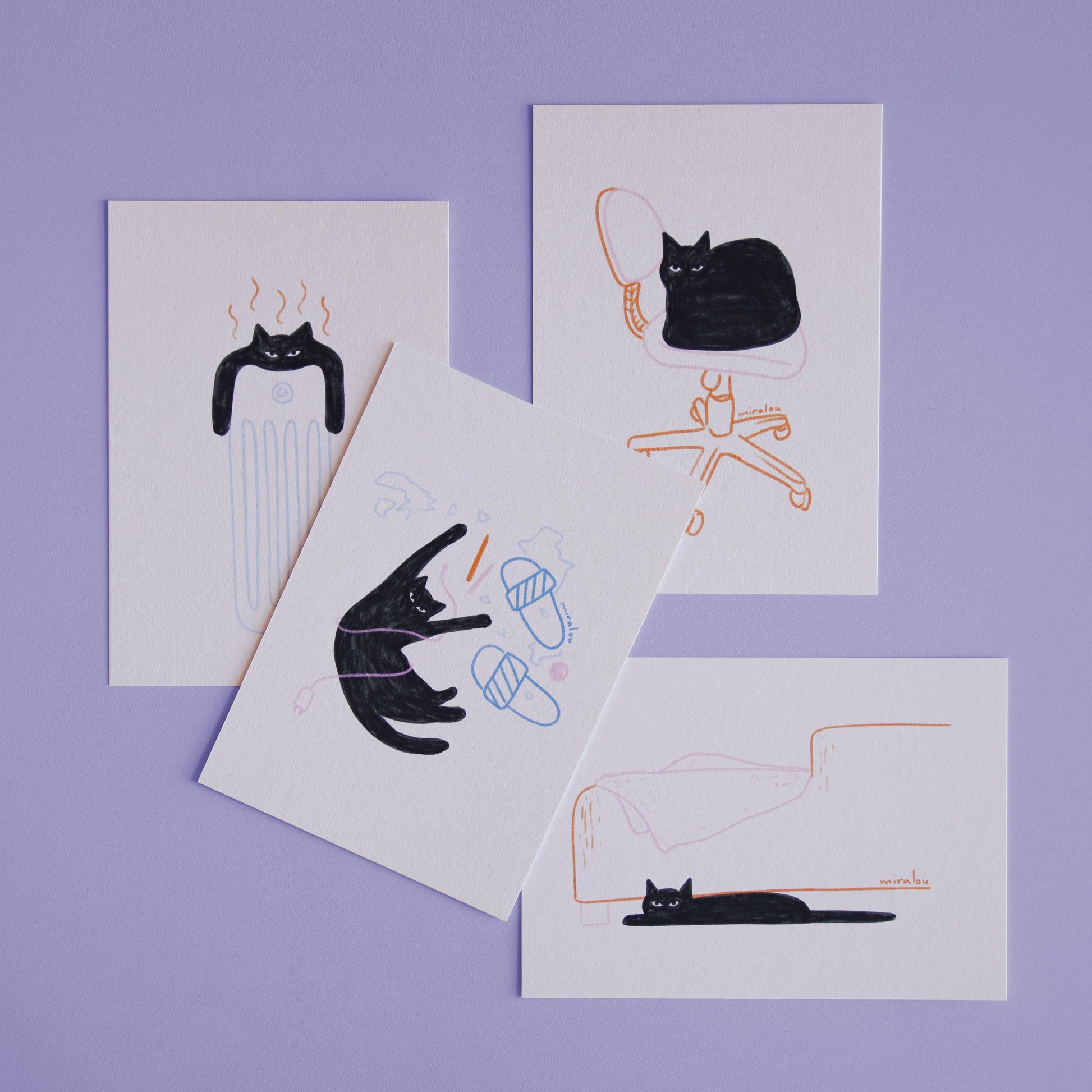 postcard set with playful illustrations of a black cat