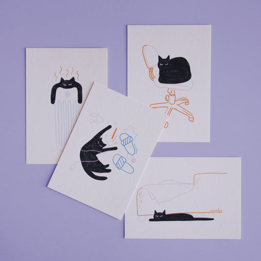 postcard set with playful illustrations of a black cat