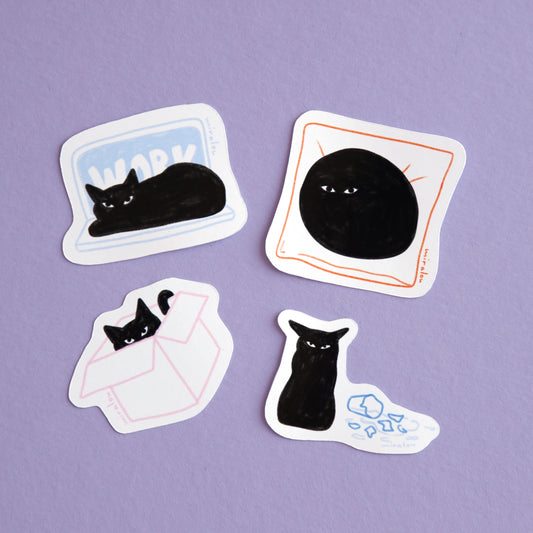 a sticker set of four playful designs of a black cat