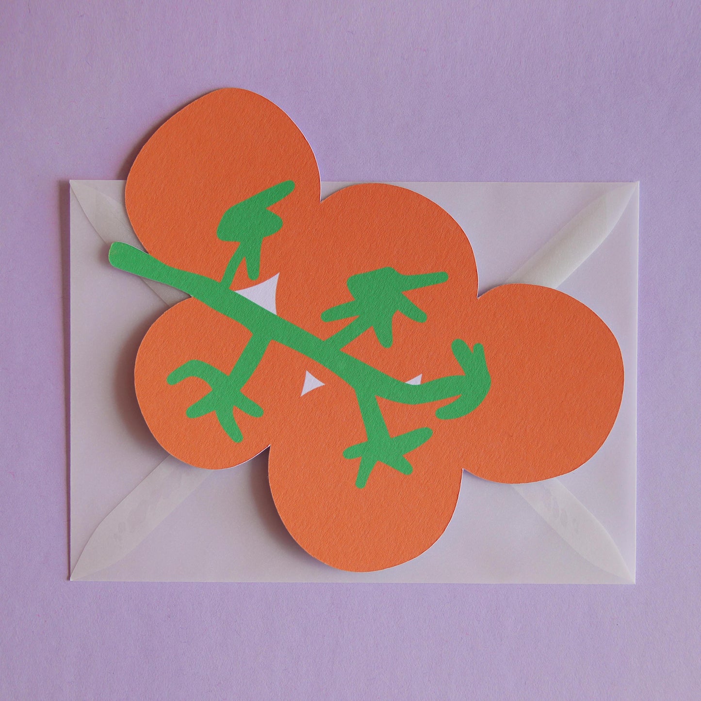 a postcard shaped like a bunch of tomatoes on a transparent envelope