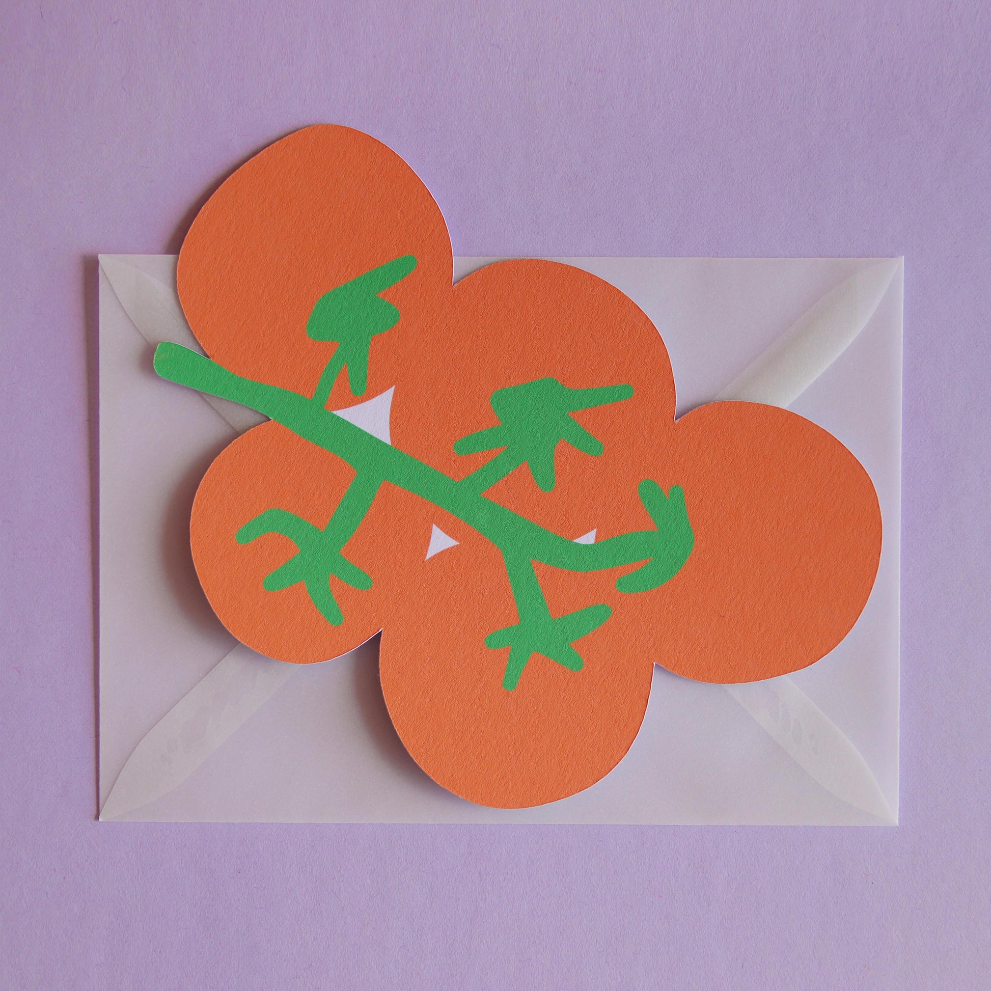 a postcard shaped like a bunch of tomatoes on a transparent envelope