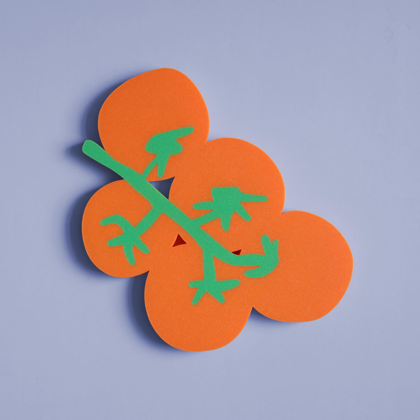 colorful wall decor in the shape of a bunch of tomatoes 